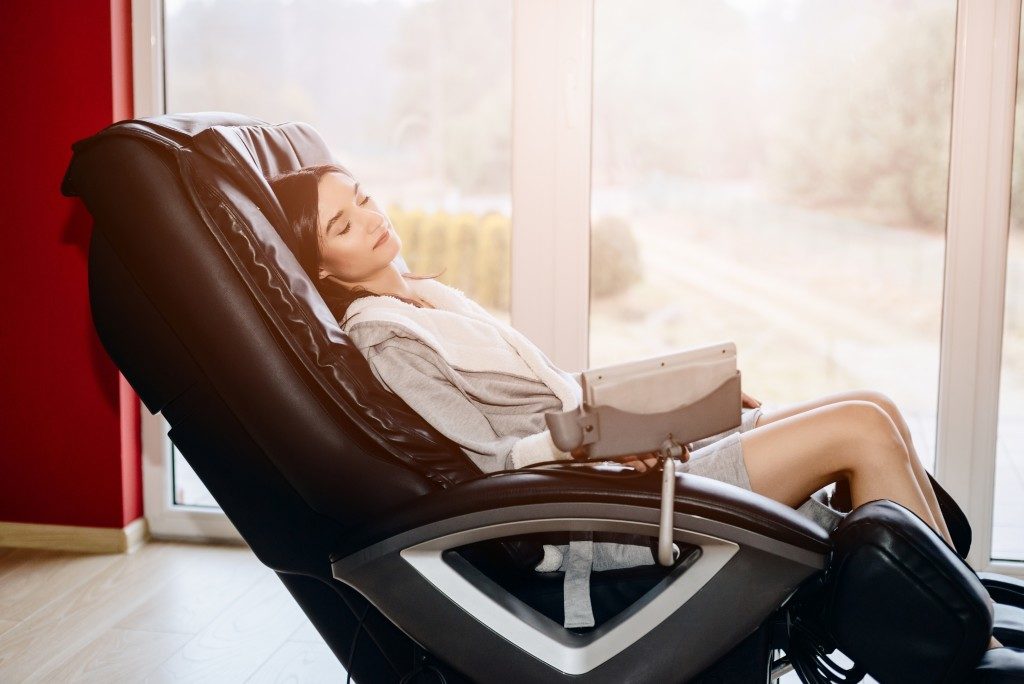 Woman relaxing on a massage chair