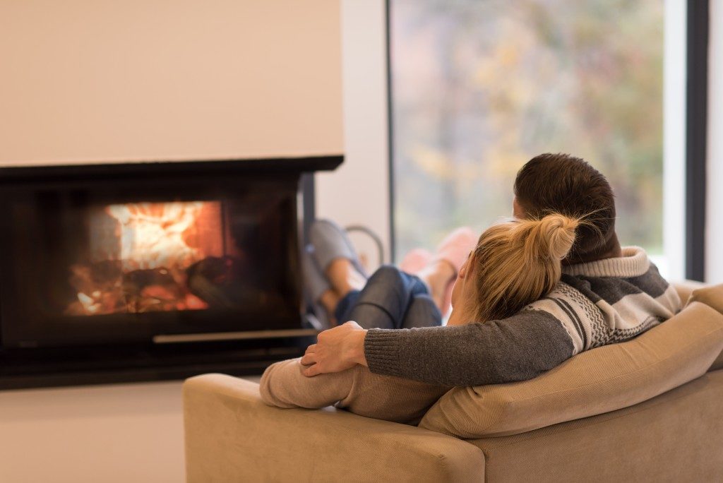 Couple hanging out near the fireplace