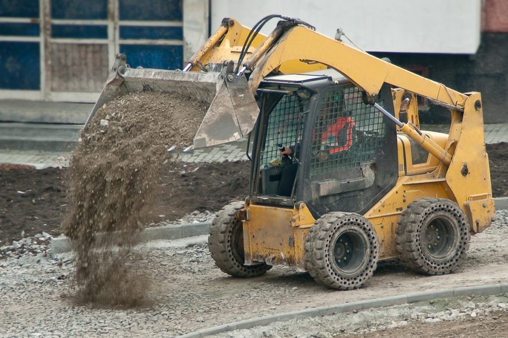 Heavy machine unloading sand
