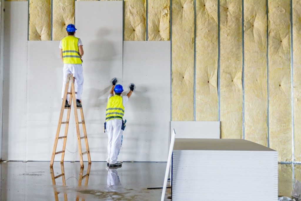 contractors installing drywall