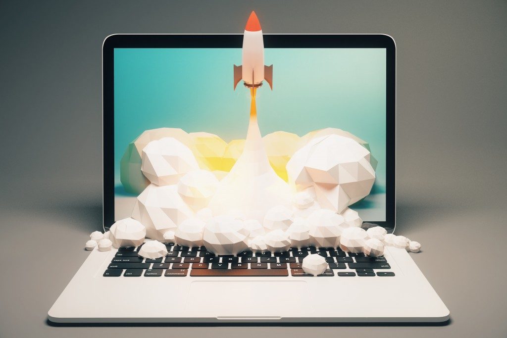 3D graphics of rocket launching out of laptop screen