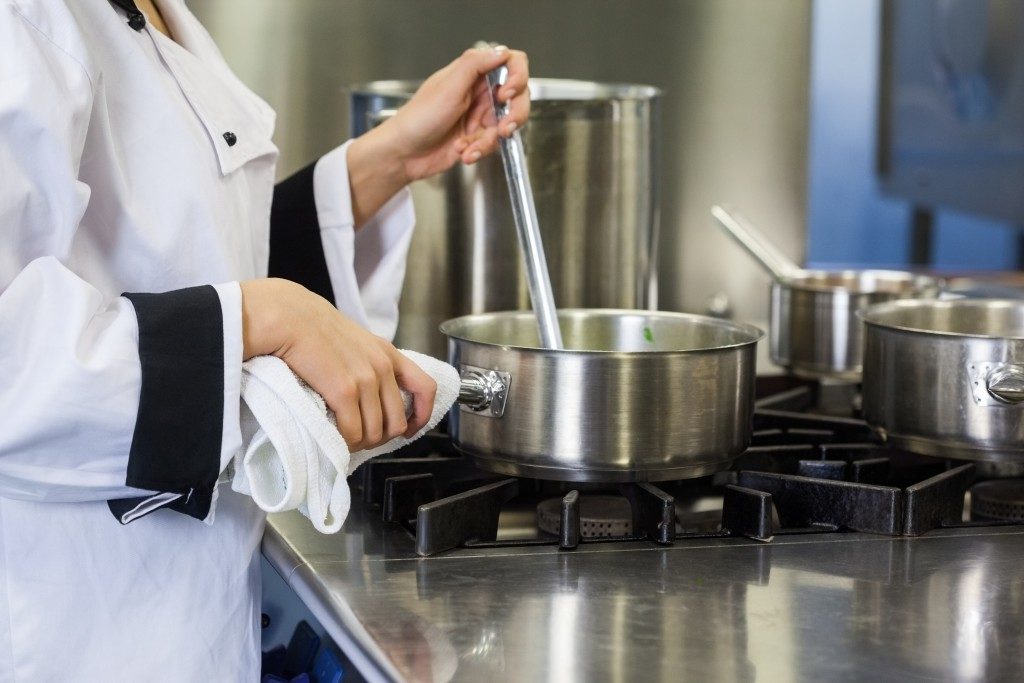 chef stirring food on the pan