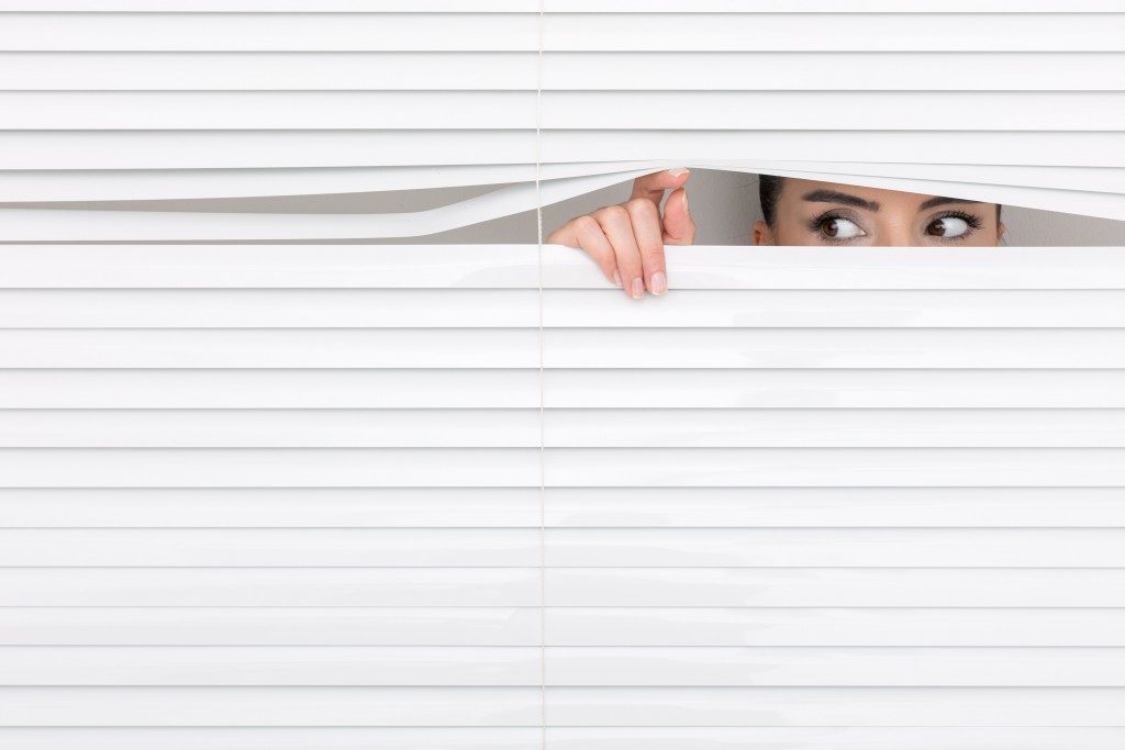 woman peeking through the window
