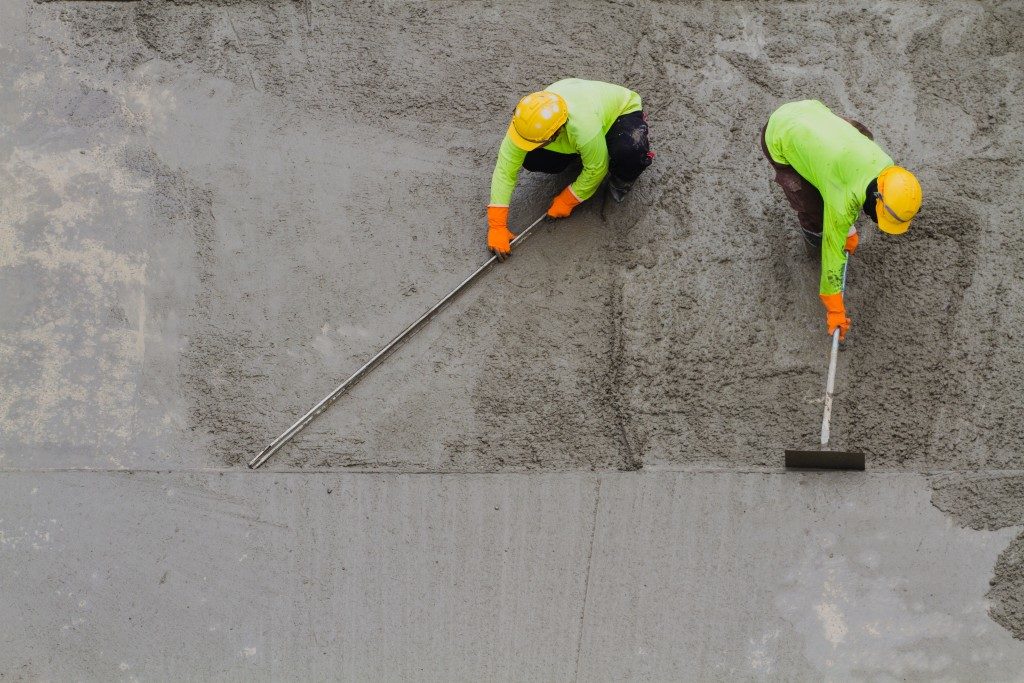 men paving concrete