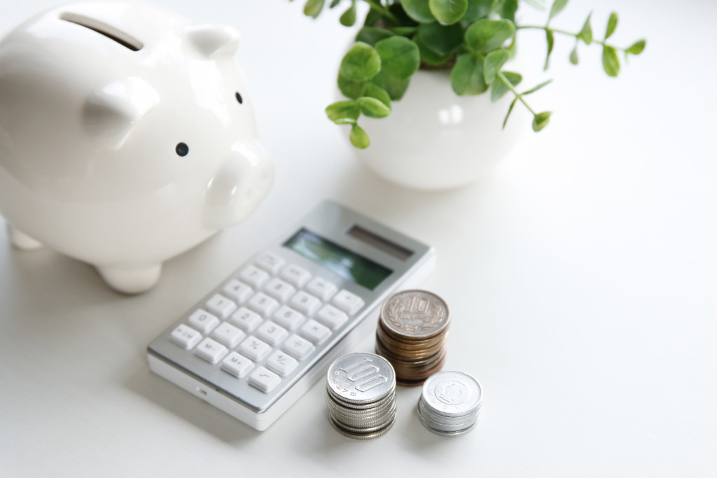 piggy bank, calculator and coins