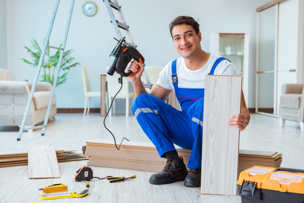 handyman with a drill and plank