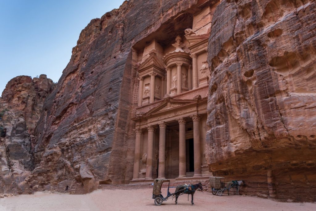 ancient building carved into the mountain side