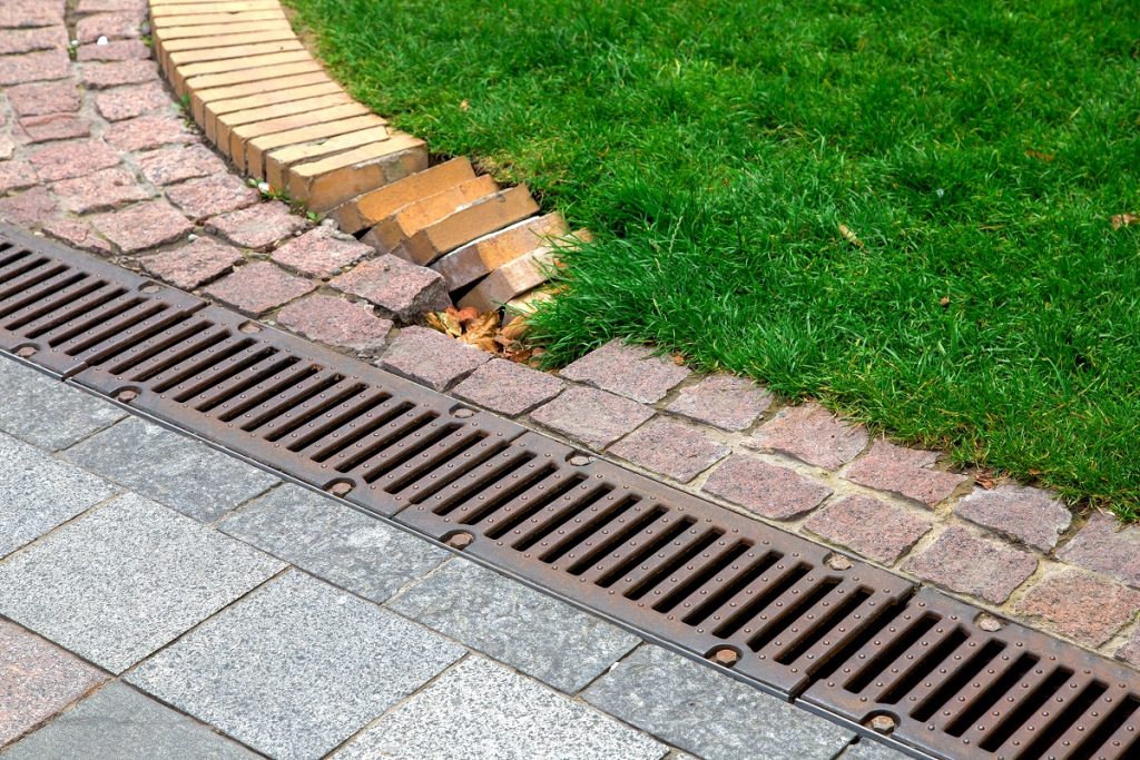 drainage grate on a pedestrian sidewalk