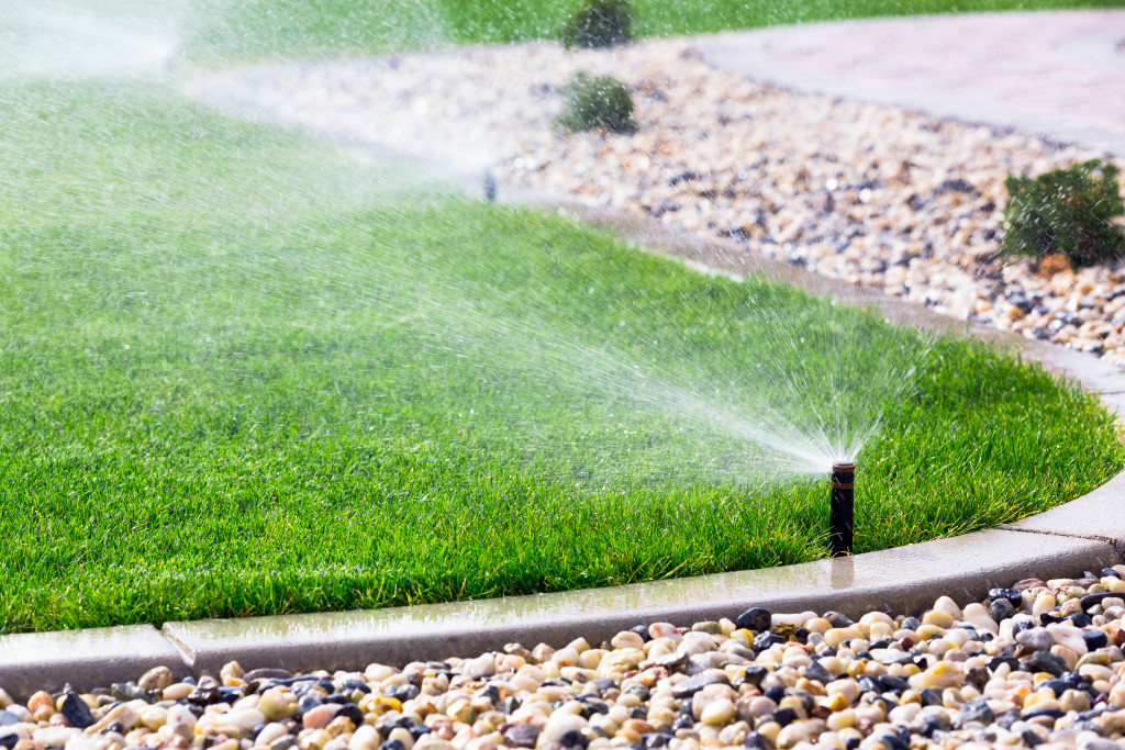 a backyard with a working water sprinkler