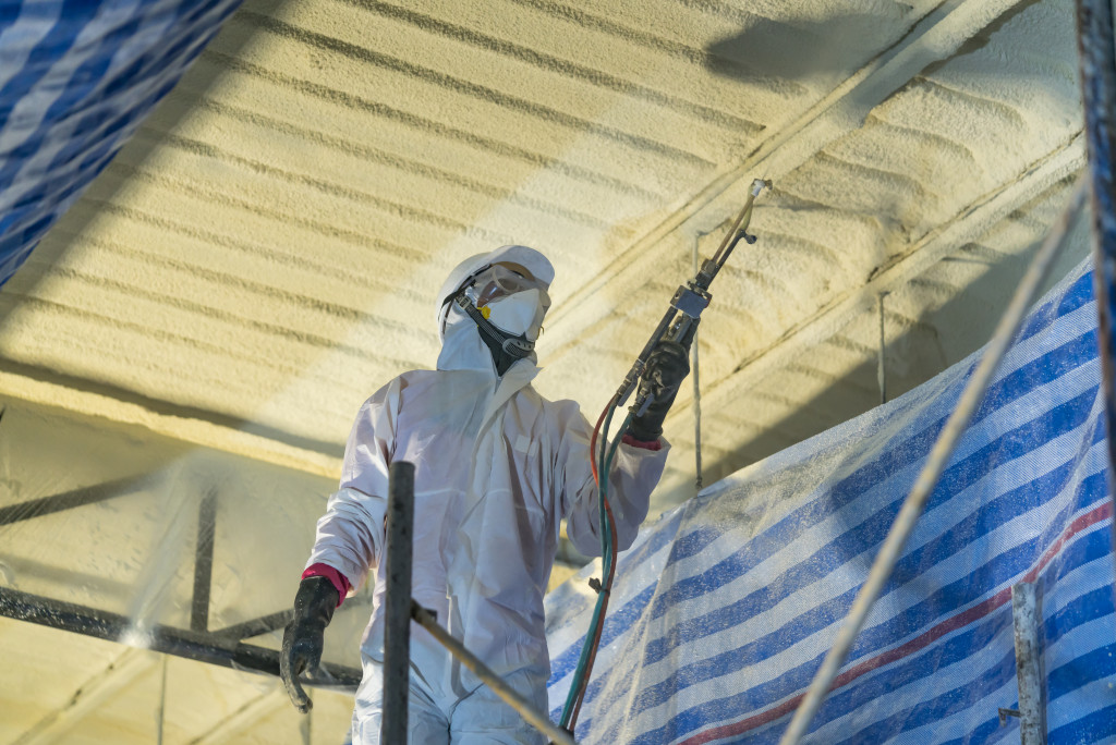 a worker adding insulation to the home's roof