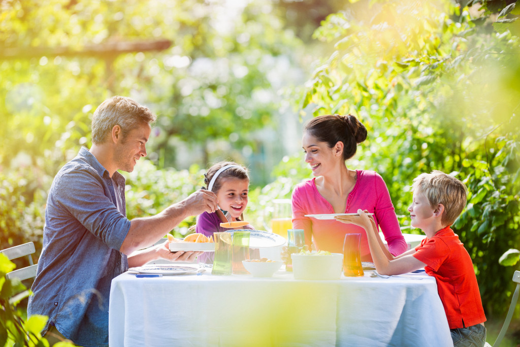 A family eating a meal outdoors