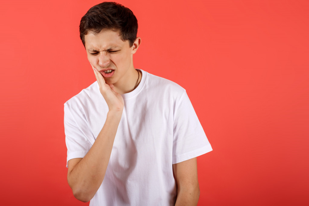 young man tooth pain