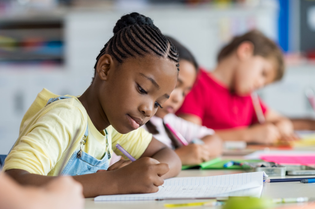 Student girl doing test in primary school. 