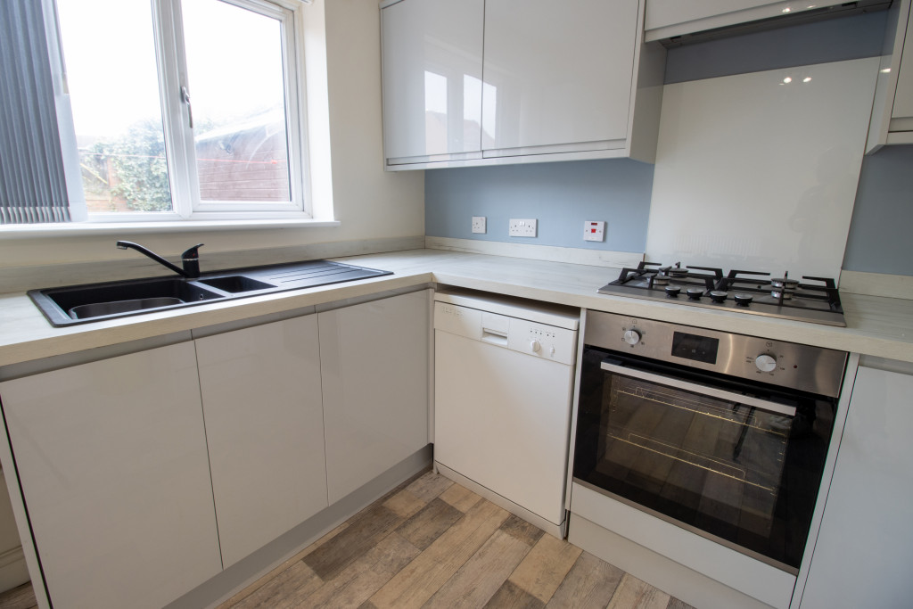 a modern kitchen with stove and kitchen sink